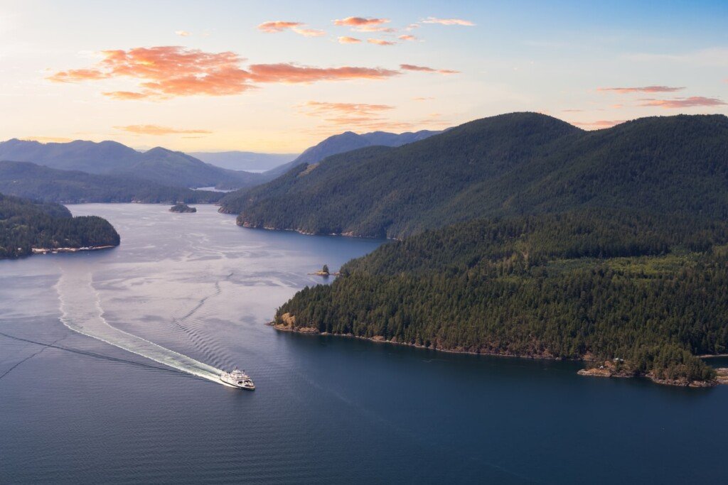 Aerial view of the Ferry traveling between the islands near the sunshine coast (desolation sound) during a sunny summer evening.