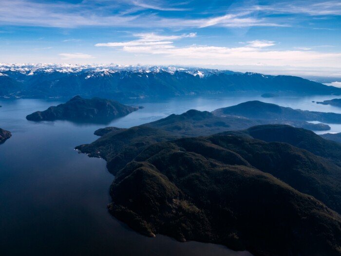 Views of Gambier Island with the coast mountains in the background.