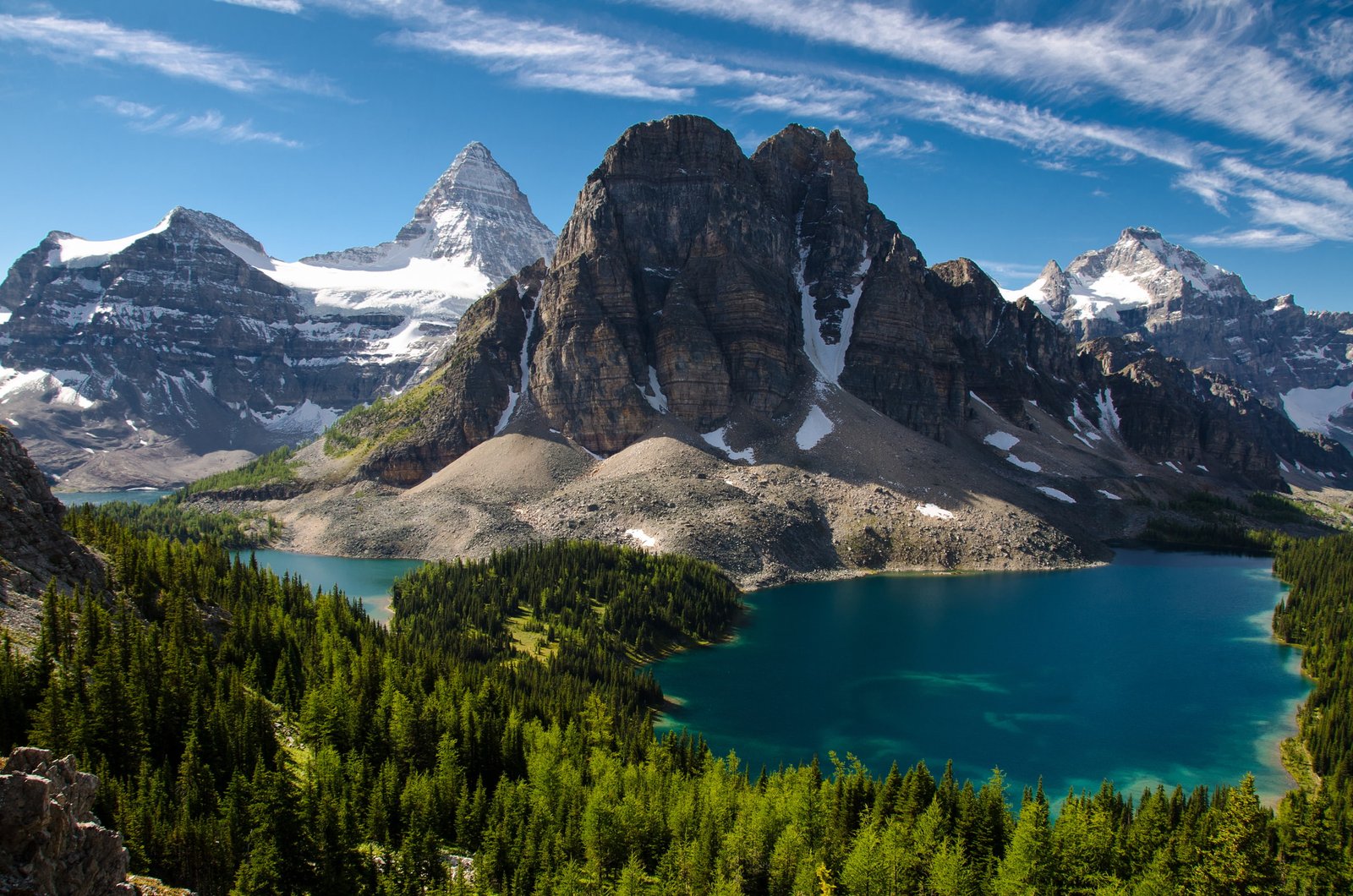 Hiking views of Mount Assiniboine rising majestically over blue lakes.