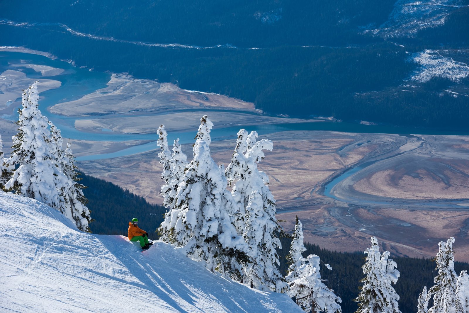 A snowboarder on the slopes at Revelstoke Mountain Resort.