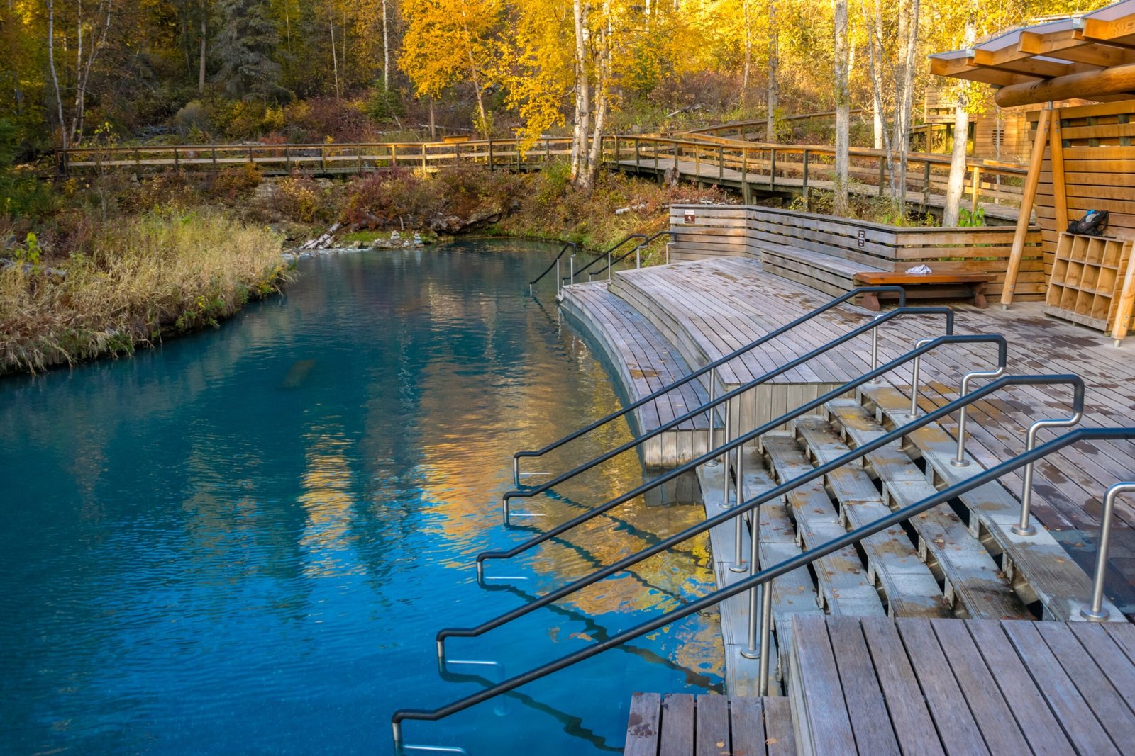 Liard River Hot Springs surrounded by bright autumn leaves.