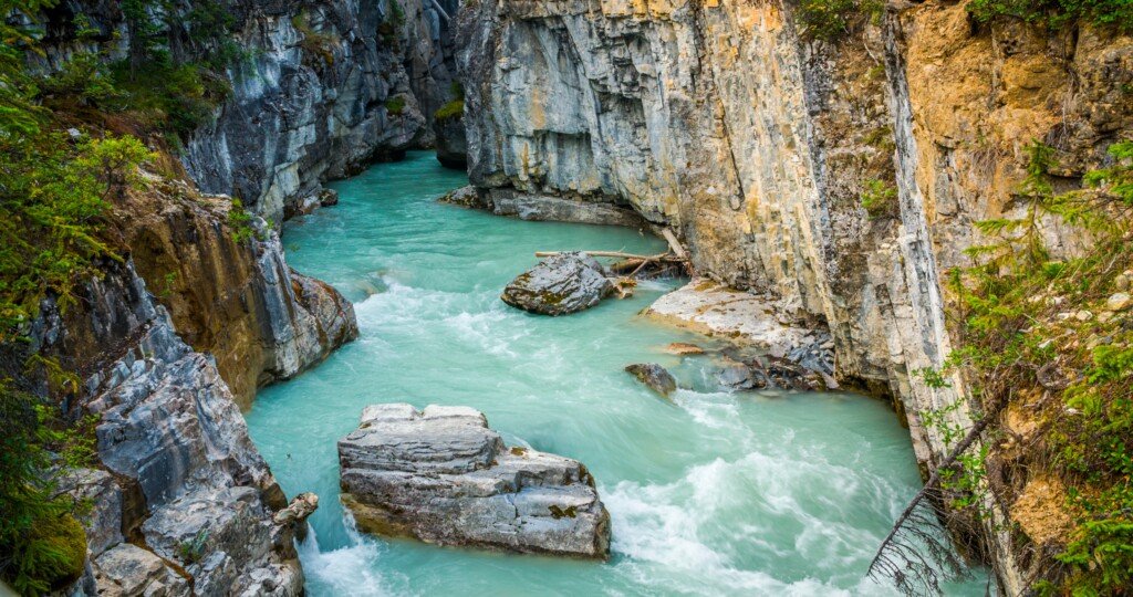 Beautiful turquoise coloured water flowing through Marble Canyon in Kootenay National Park, British Columbia.