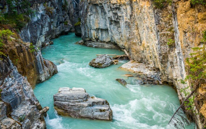 Beautiful turquoise coloured water flowing through Marble Canyon in Kootenay National Park, British Columbia.