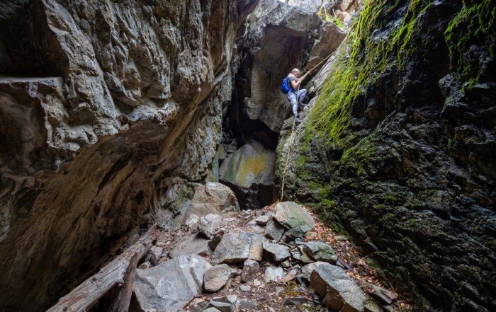 Rocky cave climbing in Skaha Bluffs Provincial Park, Penticton, British Columbia.