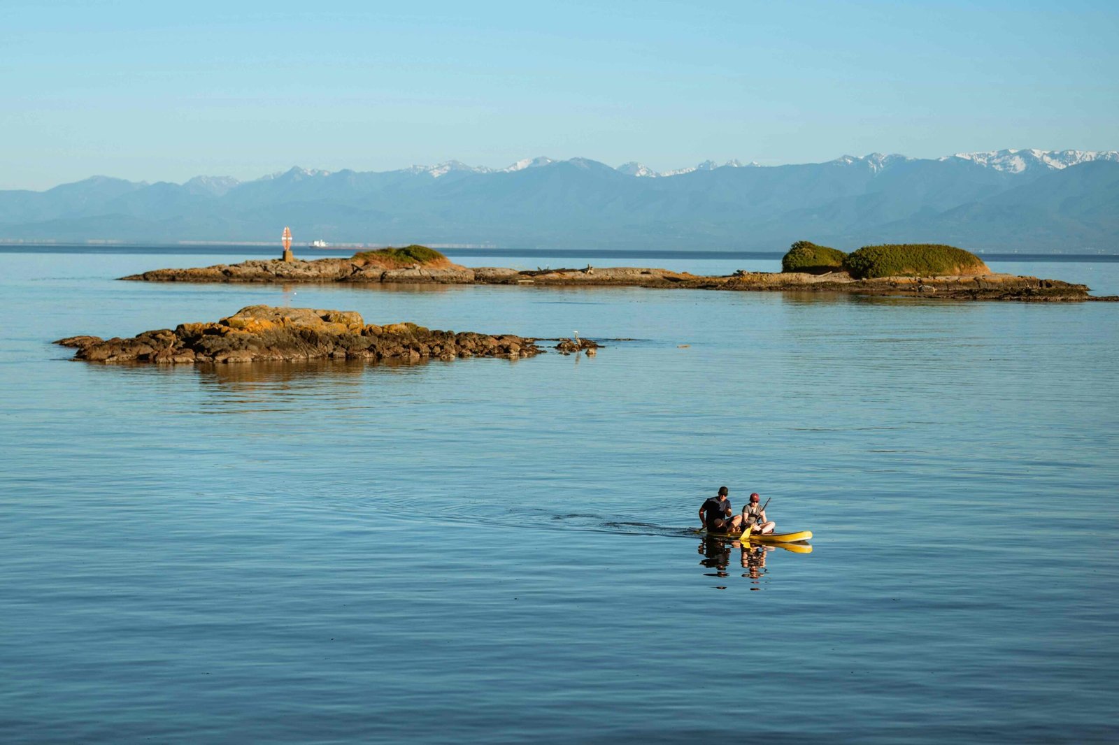 People kayaking Quadra Island in British Columbia during fall