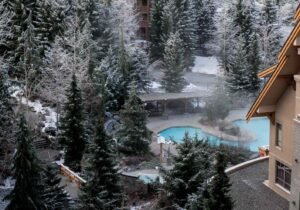 British Columbia wellness retreats: Steaming outdoor hot pools surrounded by snow-covered trees at British Columbia wellness retreats in Whistler